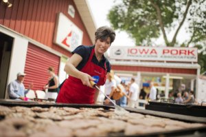 Joni Ernst, Iowa Republican Senate candidate, helps out on the grill in the Pork Tent at the 2014 Iowa State Fair.