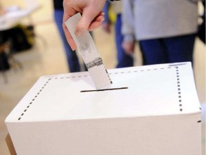 A voter casts her ballot.