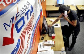 A worker for Mi Familia Vota in Phoenix works to get out the vote in 2012. Opponents of a new state election law – which they say is intended to discourage voting by minorities – are challenging it with a ballot measure.
