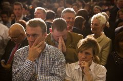 Charlie Baker supporter prays as Baker's lead fluctuates. (Jesse Costa/WBUR)