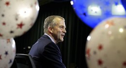 Republican Senate candidate Dan Sullivan is seen through balloons as he takes part in a television interview on election night, Tuesday, Nov. 4, 2014, in Anchorage Alaska. | AP Photo