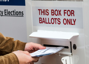 Voters turn in their ballots.